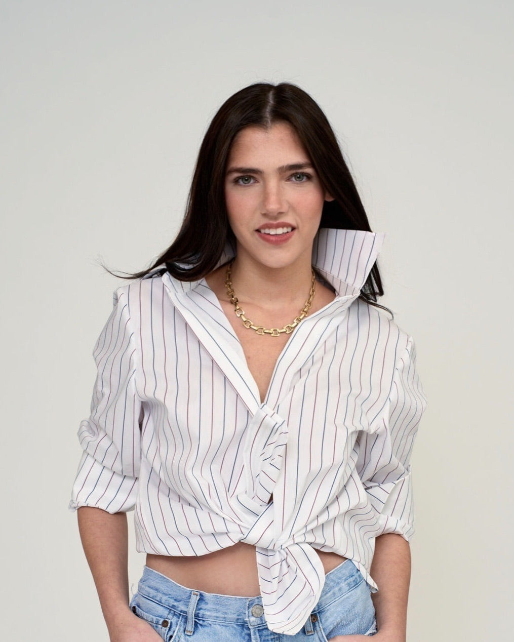 TheKno women’s vertical striped blouse styled with high-waisted denim